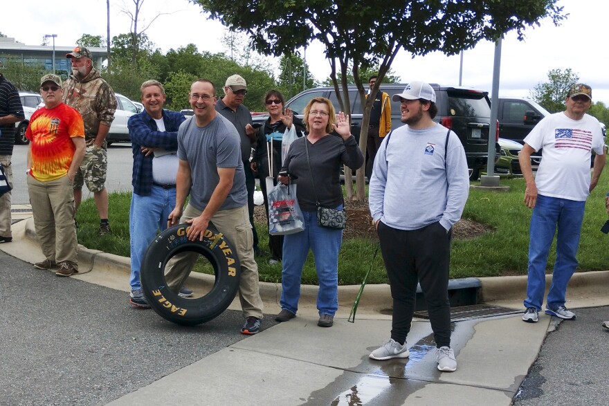 Dale Earnhardt fans gathered outside Hendrick Motorsports in Concord on Tuesday as Earnhardt talked about his retirement inside. That's Travis Parsons of Des Moines with a tire he got at the team shop. 