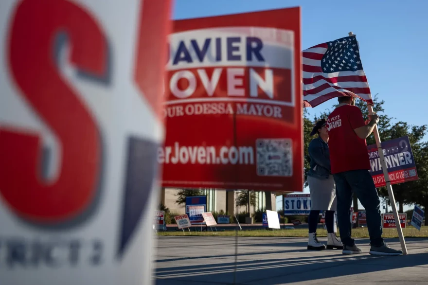 Landry Pugh and his wife Christina Pugh campaign on behalf of City Council incumbent Denise Swanner and other candidates outside a polling location on Election Day in Odessa.