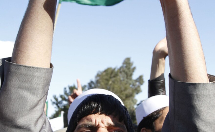 After U.S. troops burned Qurans last month, Afghans staged protests throughout the country. Here a demonstrator holds a Quran in the eastern city of Jalalabad on Feb. 22.