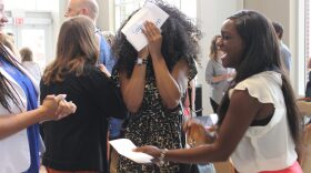 Teach for America member Symone Thompson (center) reacts during an Induction Placement Ceremony, after finding out she would be teaching at Oklahoma City's Millwood Arts Academy in the fall.