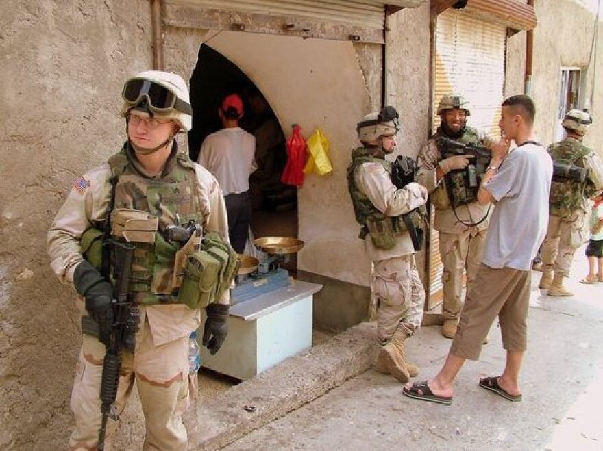 Sergeant Jason Hansman, left, on patrol in Mosul, Iraq. He was deployed there from 2004 to 2005; now, Hansman works for the Iraq and Afghanistan Veterans of America, helping to support fellow vets.