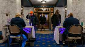 wo testers sit at a table waitig for ptients