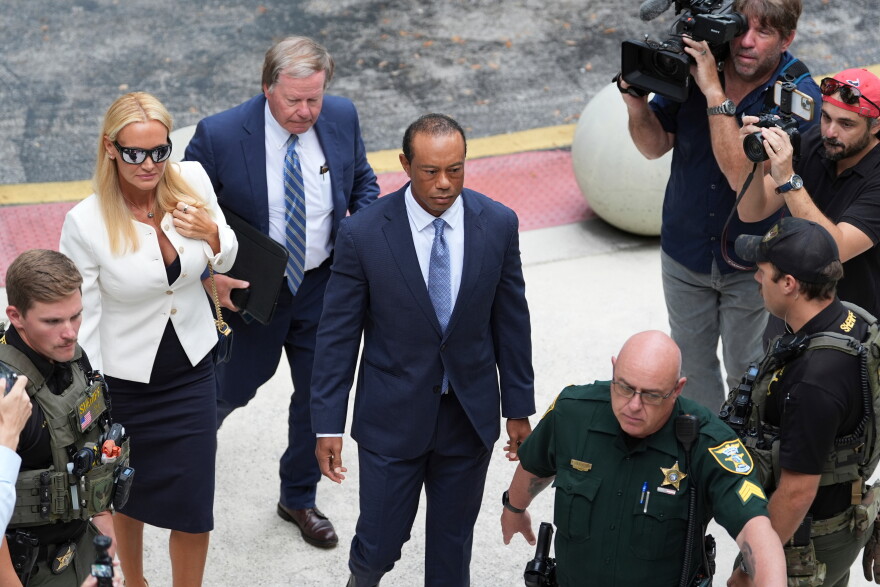 Golfer Tiger Woods, right, arrives with Vanessa Trump, left, for Woods' plea conference 
