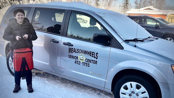 Fairbanks Senior Center Meals on Wheels volunteer coordinator Ashley Edginton carries a tote of food for a delivery run March 4, 2026. Edginton’s delivery list includes several food-insecure veterans. But as a group, she said, they can be really hard to reach.