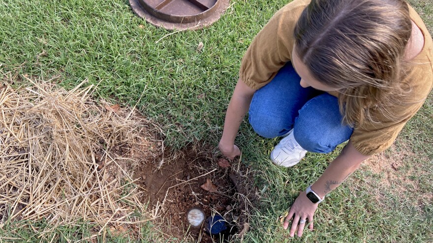 Claire Ahalt inspects her water meter outside of her home in Birmingham, Alabama, on Sept. 28, 2023.