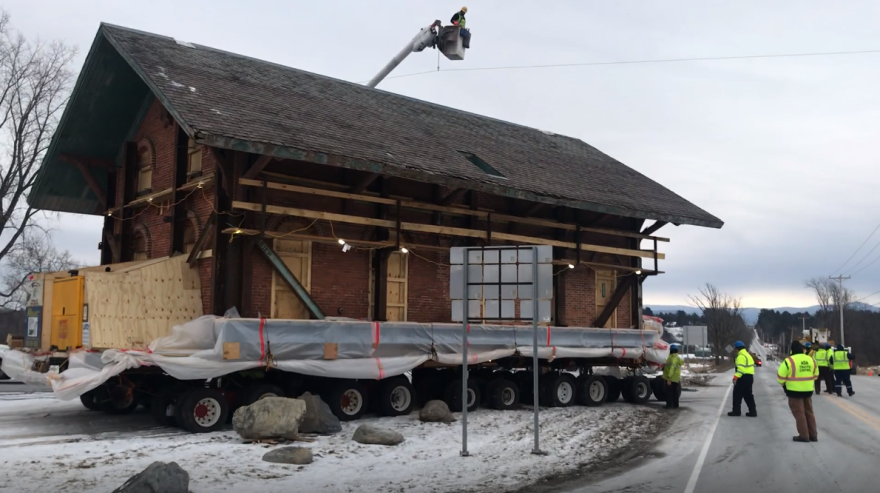  Crews maneuver a 150-year-old train station onto Route 17 in New Haven. They're moving the building to make way for new Amtrak service slated to begin later this year.