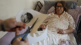 Melissa Sydor-Kauffman cuts out a logo for the new homeless advocacy program, La Madonna Della Strada, to hang on the wall. Sister Grace Miller, who dedicated her life’s work to the care and wellbeing to Rochester's homeless at the House of Mercy, the shelter she founded lies in a hospital bed at a congregation home where she is being cared for by her supporters and friends.