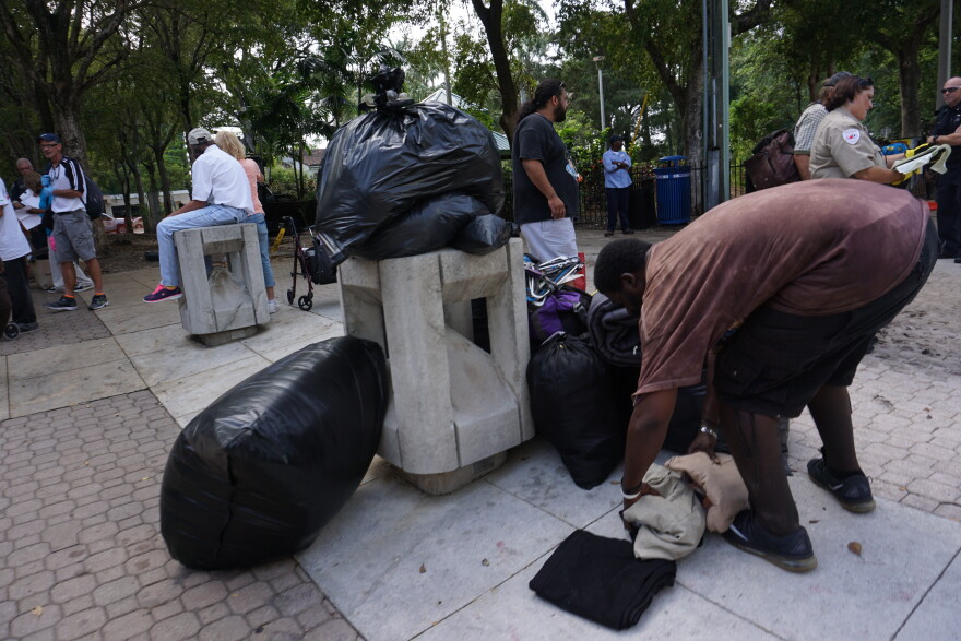 People living with homelessness in Fort Lauderdale's Downtown Stranahan Park are used to keeping their clothes for job interviews, blankets, personal documents and other belongings, in bags and under tarps inside the park square.