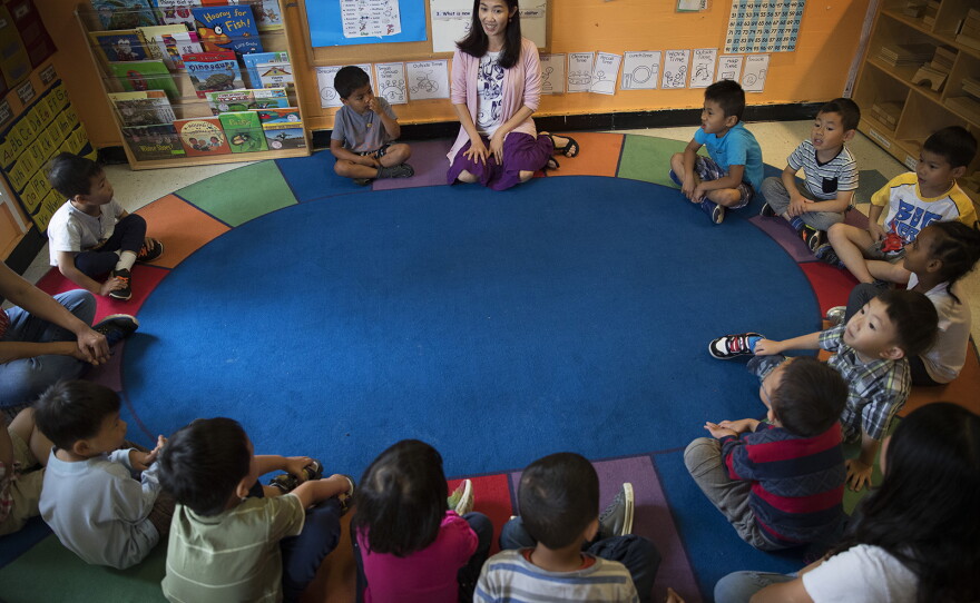 Seattle Preschool Program teacher Hien Do, center, sits in a circle with her students on Wednesday, June 28, 2017, at the ReWA Early Learning Center at Beacon, in Seattle, Washington. 