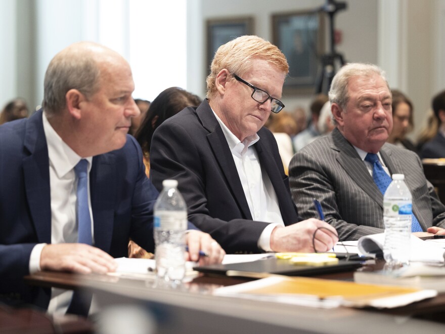 The legal team for Alex Murdaugh, center, is presenting their closing argument in his double murder trial on Thursday. He's seen here listening to prosecutor Creighton Waters make his closing arguments at the Colleton County Courthouse in Walterboro, S.C.