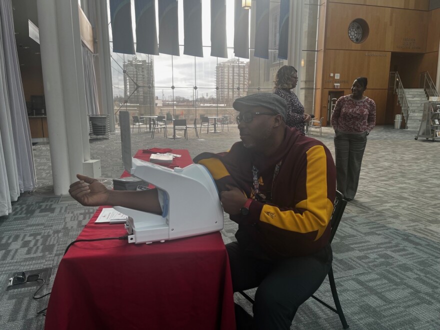 A community member gets his blood pressure tested at the Central Library in downtown Indianapolis.