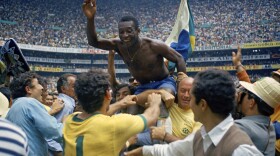 FILE - Brazil's Pele is hoisted on the shoulders of his teammates after Brazil won the World Cup final against Italy, 4-1, in Mexico City's Estadio Azteca, June 21, 1970. Pelé, the Brazilian king of soccer who won a record three World Cups and became one of the most commanding sports figures of the last century, died in sao Paulo on Thursday, Dec. 29, 2022. He was 82. (AP Photo, File)