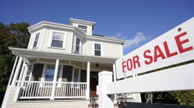 A for sale sign is displayed in front of a house in Westwood, Mass. 