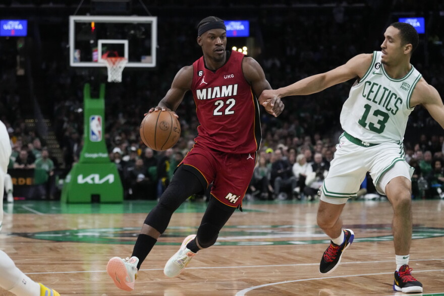 Miami Heat forward Jimmy Butler (22) drives to the basket against Boston Celtics guard Malcolm Brogdon (13) in the first half of Game 1 of the NBA basketball Eastern Conference finals playoff series in Boston, Wednesday, May 17, 2023.