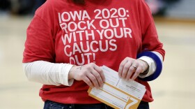 A local resident holds a Presidential Preference Card during an Iowa Democratic caucus at Hoover High School, Monday, Feb. 3, 2020, in Des Moines, Iowa.