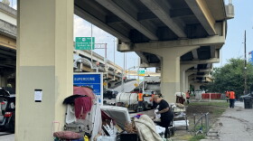 Residents of a homeless encampment clean up their belongings after the city issued an order to vacate an area along Calliope St. New Orleans has stepped up encampment sweeps as part of a broader effort to get unhoused people off the street.