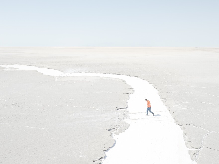 Iran's Lake Urmia has shriveled because of water mismanagement. Photographer Maximilian Mann traveled to northwest Iran to document life in the region. Here, a man walks in what used to be a river to the lake, now just salt.
