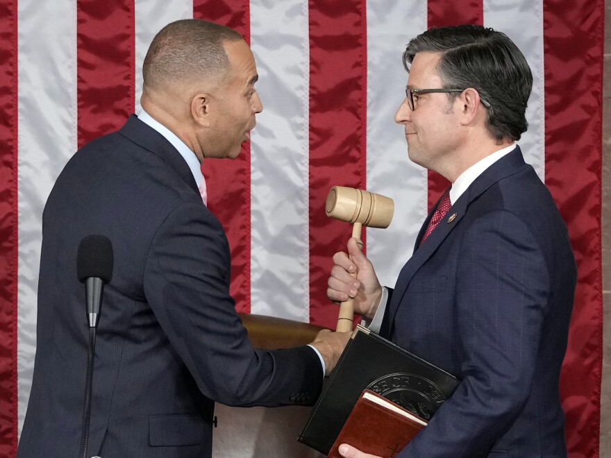 House Minority Leader Hakeem Jeffries of N.Y., hands the gavel to newly elected House Speaker Mike Johnson of Louisiana at the Capitol on Wednesday.