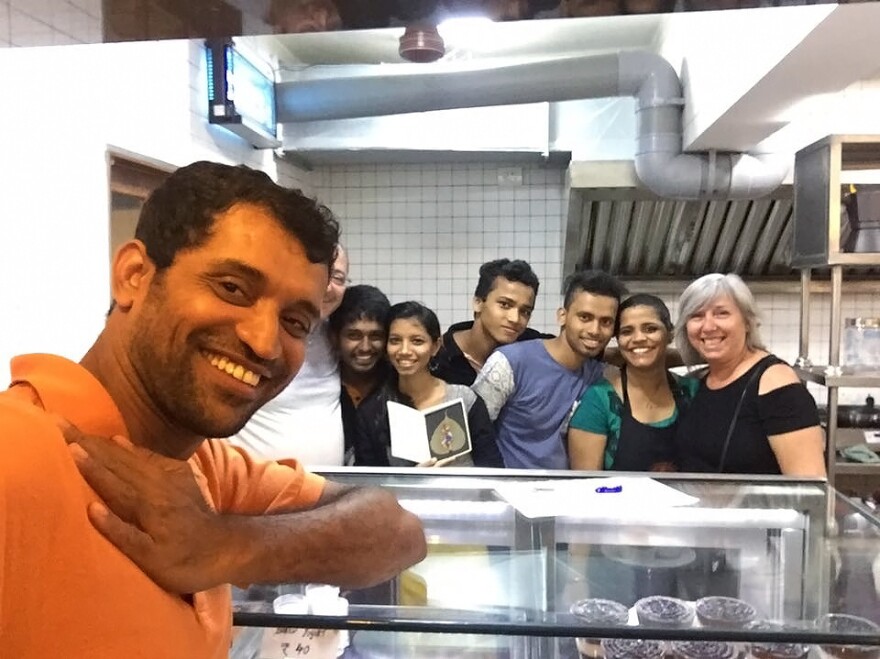 Amin Sheikh, the owner of Bombay to Barcelona Library Cafe along with his employees.