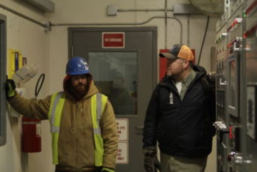 Buckland water plant operator Erik Weber, left, stands inside the village’s powerhouse last week. (Photo by Nathaniel Herz / Alaska’s Energy Desk)