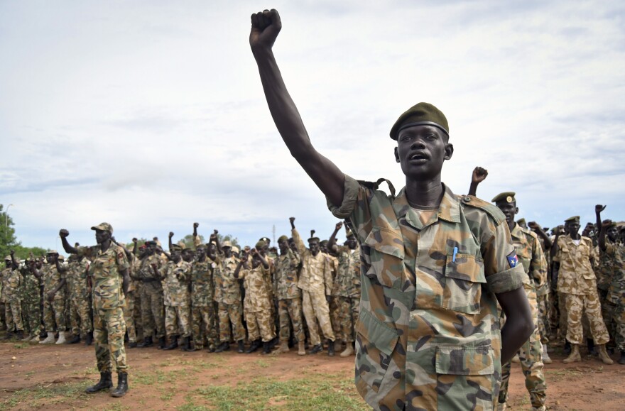 Soldiers cheer at a ceremony marking the 34th anniversary of the Sudan People's Liberation Army, attended by President Salva Kiir, in Juba on May 18.