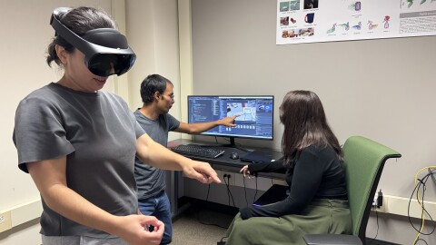 Sean Banerjee (pictured pointing at computer) will work with his wife and fellow Wright State professor Natasha Banerjee to develop a system for recycling plants to manufacture and fabricate scrap metal for U.S. consumers. With his lab students, they prototype the role augmented reality (AR) can play in assembly.