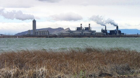 FILE - Smoke blows from the Four Corners Power Plant in Waterflow, N.M., near the San Juan River in northwestern New Mexico in April 2006. New Mexico's largest electric provider wants the state's highest court to overturn a 2021 decision by regulators who rejected a proposal to transfer shares in a coal-fired power plant to a Navajo energy company. (AP Photo/Susan Montoya Bryan, File)