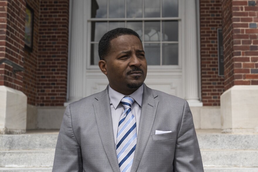 Pastor John Perry in front of City Hall in downtown Brunswick. On the justice system and the differences between how white and Black people are treated, he says, "Some people call it the good old boy system. I call it relationships of privilege."