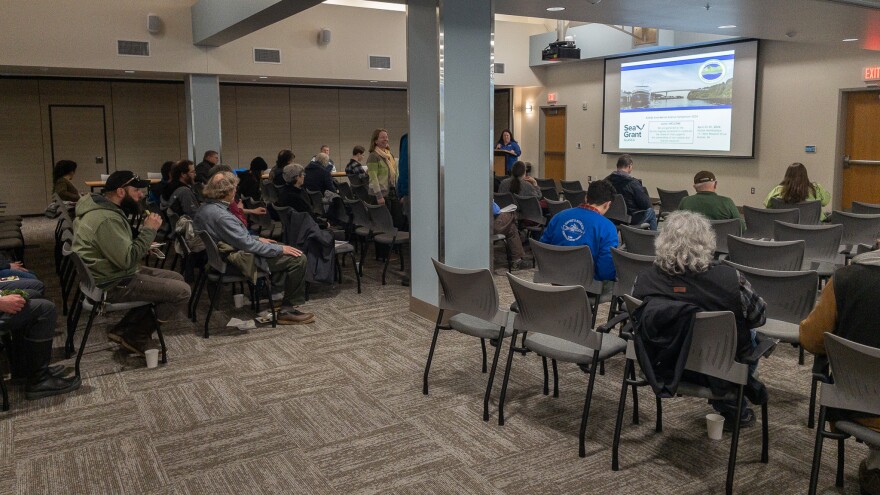 Julie Matweyou introduces Keynote Speaker Rick Thoman on the opening night of the symposium. (Brian Venua/KMXT)