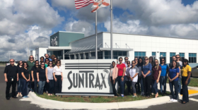 Suntrax and Women's Transportation Seminar members pose outside the facility. 