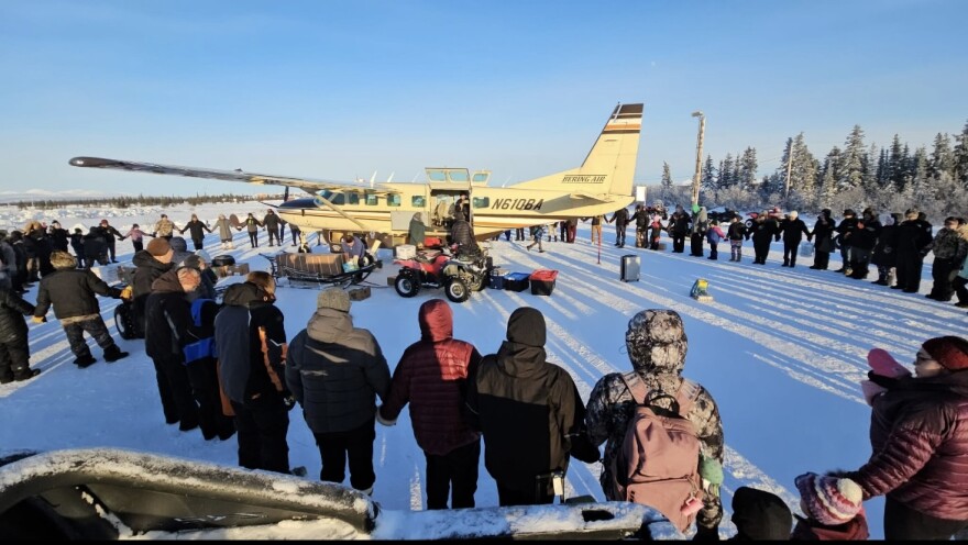 Noatak residents hold hands and form a circle around a Bering Air plane on Sat., Feb 8. 2025. People in Noatak and other villages across Northwest Alaska came out to their airstrips to support the airline employees and pay respect to the victims of the crash of flight 445 that happened near Nome. 
