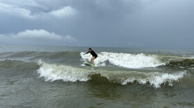 Woman Surfing Along the Delmarva Coastline