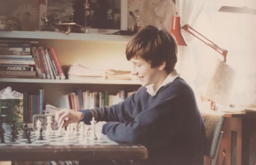 Bob Ferguson playing chess as a child in his bedroom.