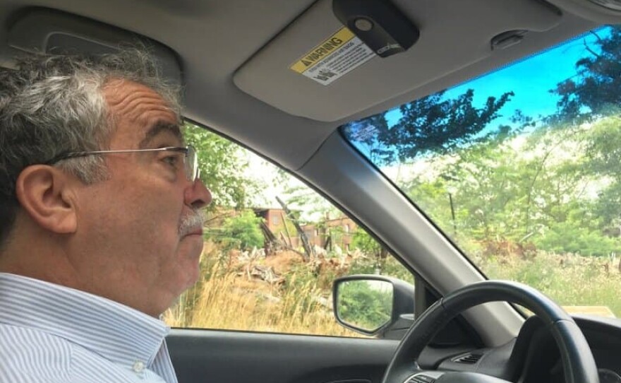 Jim Rokakis, director of the Thriving Communities Institute and a former local Democratic party official, drives on a tour through an East Cleveland, Ohio neighborhood hit hard by the housing crisis. (Jill Ryan/Here & Now)