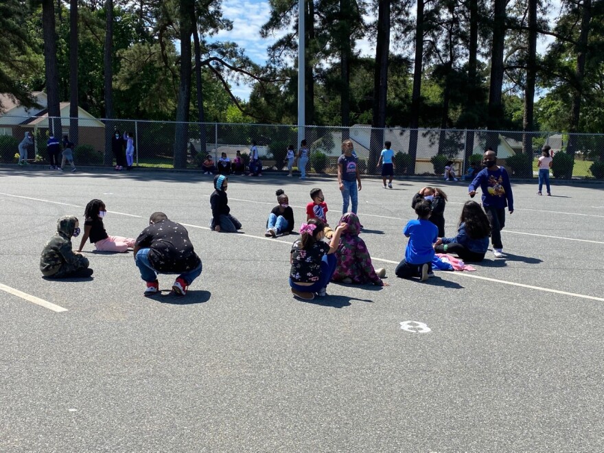 Oakdale Elementary students spend recess on the bus lot.