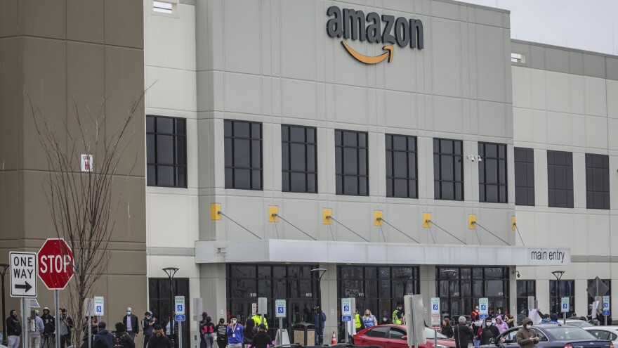 Workers at Amazon's fulfillment center in Staten Island, N.Y., gather outside to protest work conditions on March 30. More protests are being staged around the country this week.