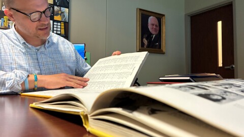 D.W. Daniel High School Principal Adam Russell looks through Lindsey Graham's senior yearbook. Graham graduated from Daniel in 1973.