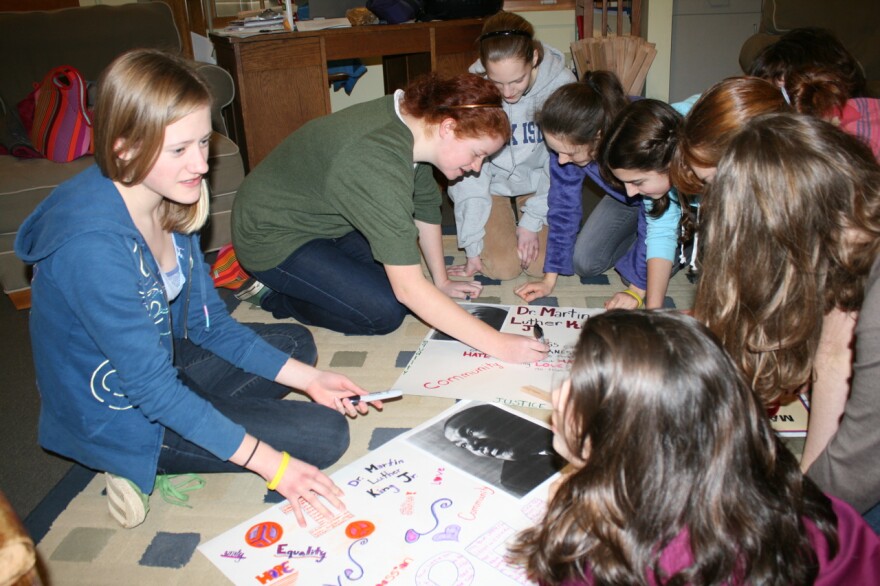 Haylee Derrickson (left) and classmates prepare for a march that kicks off their MLK lesson this year.