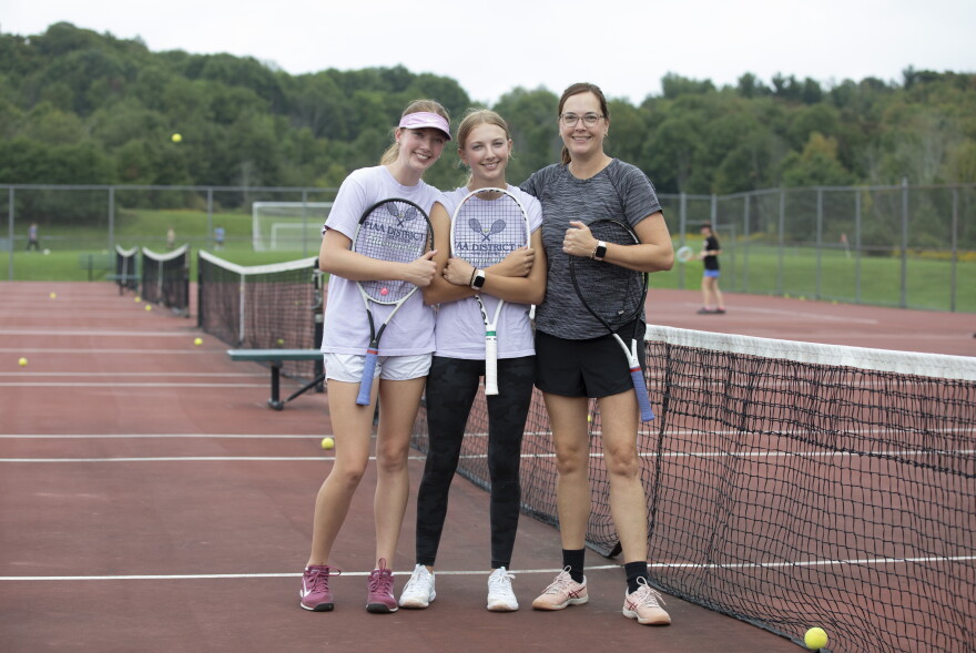 Teri Evans, right, coaches her daughters Cara, left, and Anna, center, on the Montrose girls tennis team. Cara won the Class 2A state championship last season and hopes for a repeat this year.