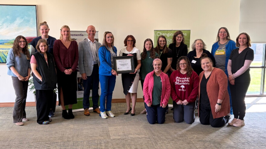 Pine Rest Christian Mental Health Services pose with accreditation certificate.