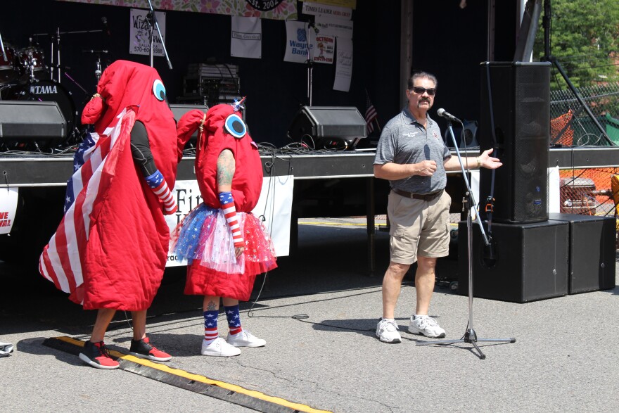 Plymouth Mayor Frank Coughlin gives opening remarks at the Plymouth Alive Kielbasa Festival Friday beside Mr. and Mrs. Kielbasa. 