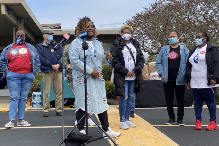 About 200 people gathered for a candlelight vigil Saturday evening to remember those who died in Thursday's mass shooting at a FedEx facility.