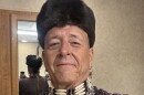 A man in Osage tribal wear takes a selfie.