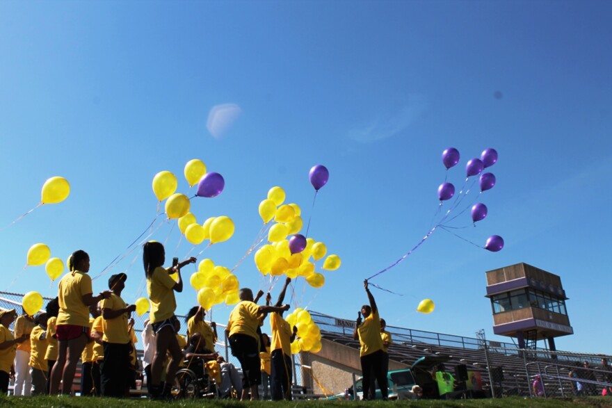 Vanessa Hughes, right, releases purple balloons in honor of her son Justin, who received a heart transplant in 1997.