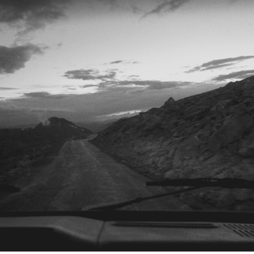 Black and white image of a desert road 