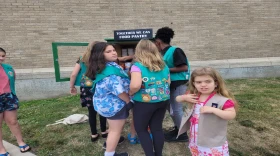 Girl Scouts fill a new food pantry on New Scotland Avenue in Albany in July 2022. (Ashley Hupfl/WAMC)