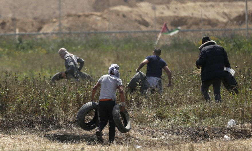 Palestinian youth brought tires close to the border to burn during Friday's protests.