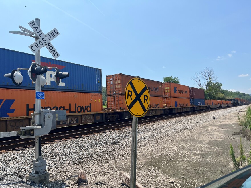 Train cars cross a railroad crossing