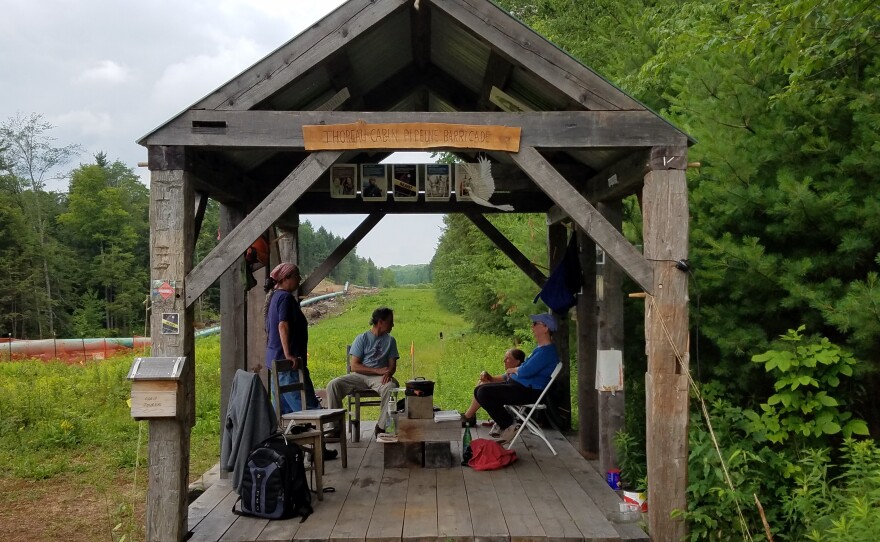 Pipeline opponents sit in what they call the Henry David Thoreau Cabin, on private land next to where a pipeline is being build in Sandisfield, Mass.