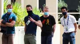 People associated with the Australian Open are seen lining up at a testing facility at the View Hotel on Thursday in Melbourne, Australia. Victoria state has reintroduced COVID-19 restrictions after a hotel quarantine worker tested positive for the coronavirus on Wednesday.